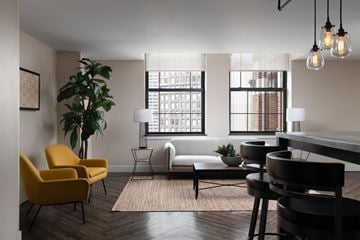 Detroit apartment for rent - a living room with a couch and a table and chairs