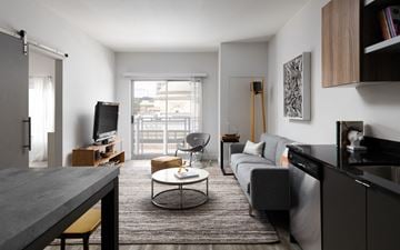 Detroit apartment for rent - a living room with a couch and a table and a television