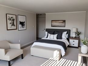Taylor townhouse for rent - A bedroom with a large bed and a chair.