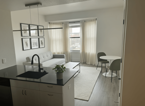Detroit apartment for rent - A modern kitchen with a black countertop and white appliances.