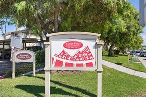 San Diego apartment for rent - a sign in front of a building with a red and white sign