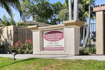 San Diego apartment for rent - a sign in front of a building with palm trees