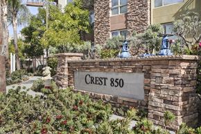 San Marcos apartment for rent - a stone wall with a sign that reads crest 860 in front of a building
