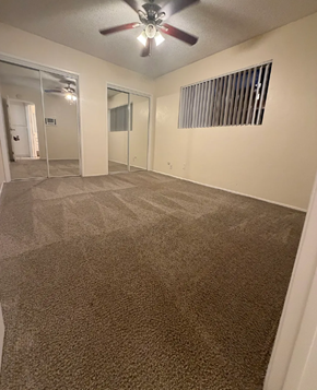 San Diego apartment for rent - A room with a ceiling fan and carpeted floor.
