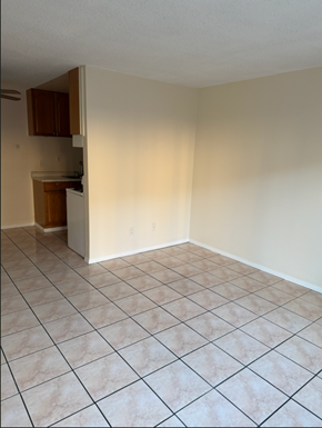 National City apartment for rent - A kitchen with a white tile floor and a white wall.