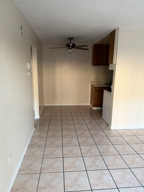 National City apartment for rent - A room with a ceiling fan and tiled flooring.