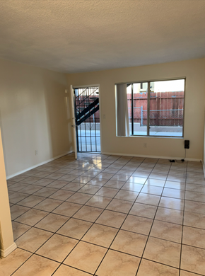 National City apartment for rent - A room with tiled flooring and a view of a staircase outside.