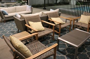 Pool pavilion with outdoor fire place a large tv and lounge area as well as restrooms with showers and lockers