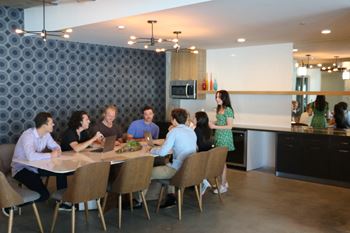 Large community room with tv, pool table, kitchen and eating area