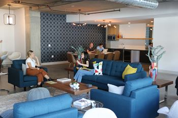 Large community room with tv, pool table, kitchen and eating area