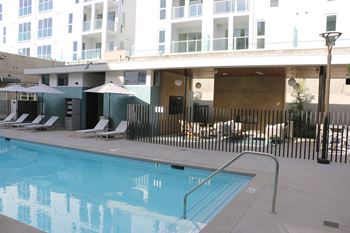 Pool pavilion with outdoor fire place a large tv and lounge area as well as restrooms with showers and lockers