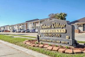 Gretna apartment for rent - A sign for Belmont Village Apartments is in front of a row of houses.