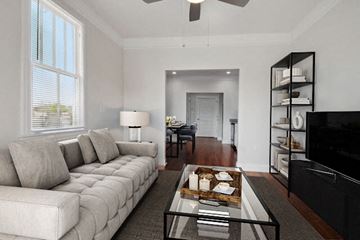 New Orleans apartment for rent - A living room with a white couch and a glass coffee table.