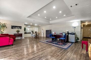 Gretna apartment for rent - A living room with a red couch and a blue chair.