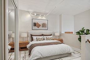 New Orleans apartment for rent - a bedroom with a bed and a painting on the wall
