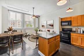 New Orleans apartment for rent - an open kitchen and dining room with a table and chairs