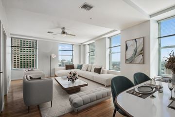New Orleans apartment for rent - a living room with a white couch and a table with chairs