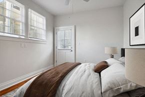 New Orleans triplex for rent - a white bedroom with a bed and a window