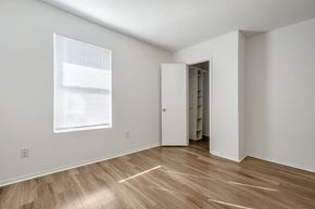Gretna apartment for rent - A room with a wooden floor and a white door.