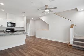 New Orleans apartment for rent - Grove Place I living room with a kitchen and a ceiling fan