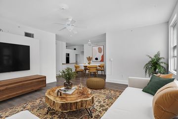 New Orleans apartment for rent - A living room with a white couch and a wooden coffee table.