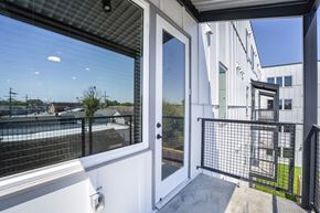 New Orleans apartment for rent - A balcony with a view of a pool and a building.