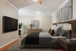 New Orleans apartment for rent - the master bedroom has a large bed and a tv