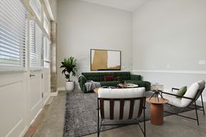 Donaldsonville apartment for rent - a living room with a green couch and two chairs