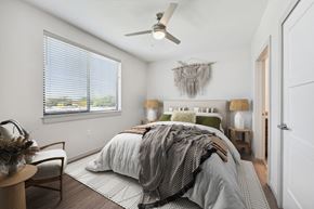 Lafayette apartment for rent - a bedroom with a large bed and a ceiling fan