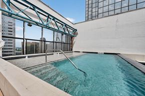 Dallas apartment for rent - A swimming pool on a rooftop with a city view.