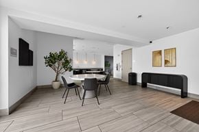 Dallas apartment for rent - A modern dining room with a white table and chairs.