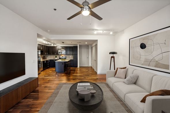 Dallas apartment for rent - A modern living room with a white sofa and a black coffee table.