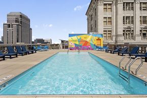 New Orleans apartment for rent - A large outdoor swimming pool with a mural on the wall.