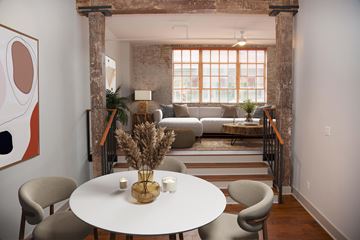 New Orleans apartment for rent - a living room and dining room with a white table and chairs