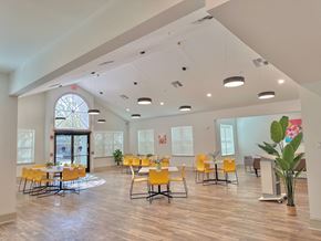 Houma apartment for rent - a dining room with yellow chairs and tables and a large window