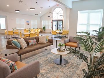 Houma apartment for rent - a living room with couches and tables and chairs in a building
