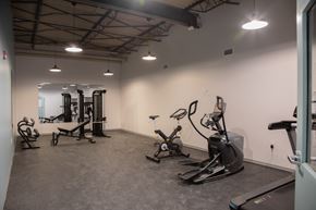 Lafayette apartment for rent - a gym with exercise equipment and lights in the ceiling