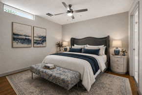 Dallas apartment for rent - A bedroom with a large bed and a ceiling fan.