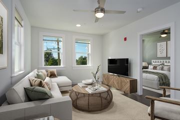 Lake Charles apartment for rent - A living room with a white couch and a television.