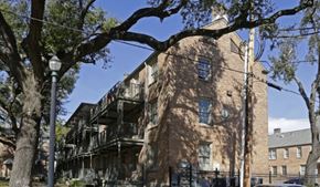 New Orleans apartment for rent - A tree in front of a building with a balcony.
