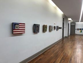New Orleans apartment for rent - A hallway with a flag and pictures on the wall.
