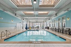 Richmond apartment for rent - A large indoor swimming pool with a glass ceiling.