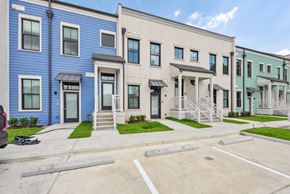 Lake Charles apartment for rent - A row of townhouses with blue and beige exteriors.