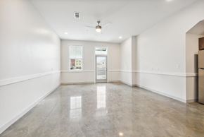 Lake Charles apartment for rent - A spacious room with a ceiling fan and a large window.