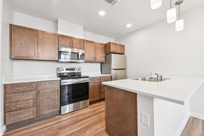 Lake Charles apartment for rent - A modern kitchen with wooden cabinets and stainless steel appliances.