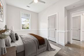 Lake Charles apartment for rent - A bedroom with a bed, a ceiling fan, and a window.