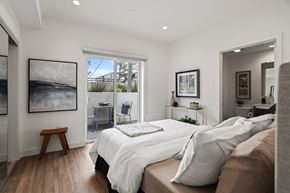 Los Angeles apartment for rent - a bedroom with a bed and a door leading to a balcony at The Fairfax Flats Apartments, Los Angeles, CA, 90019