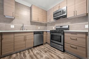 Los Angeles apartment for rent - A kitchen with wooden cabinets and black appliances at Lafayette Apartments, Los Angeles