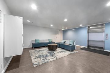 Los Angeles apartment for rent - A spacious living room with a blue sofa and a coffee table.