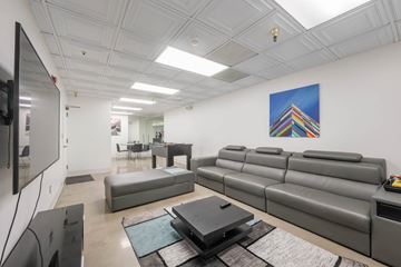 Los Angeles apartment for rent - A living room with a grey couch and a painting on the wall.